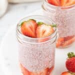 two small mason jars filled with plant based strawberry chia pudding.