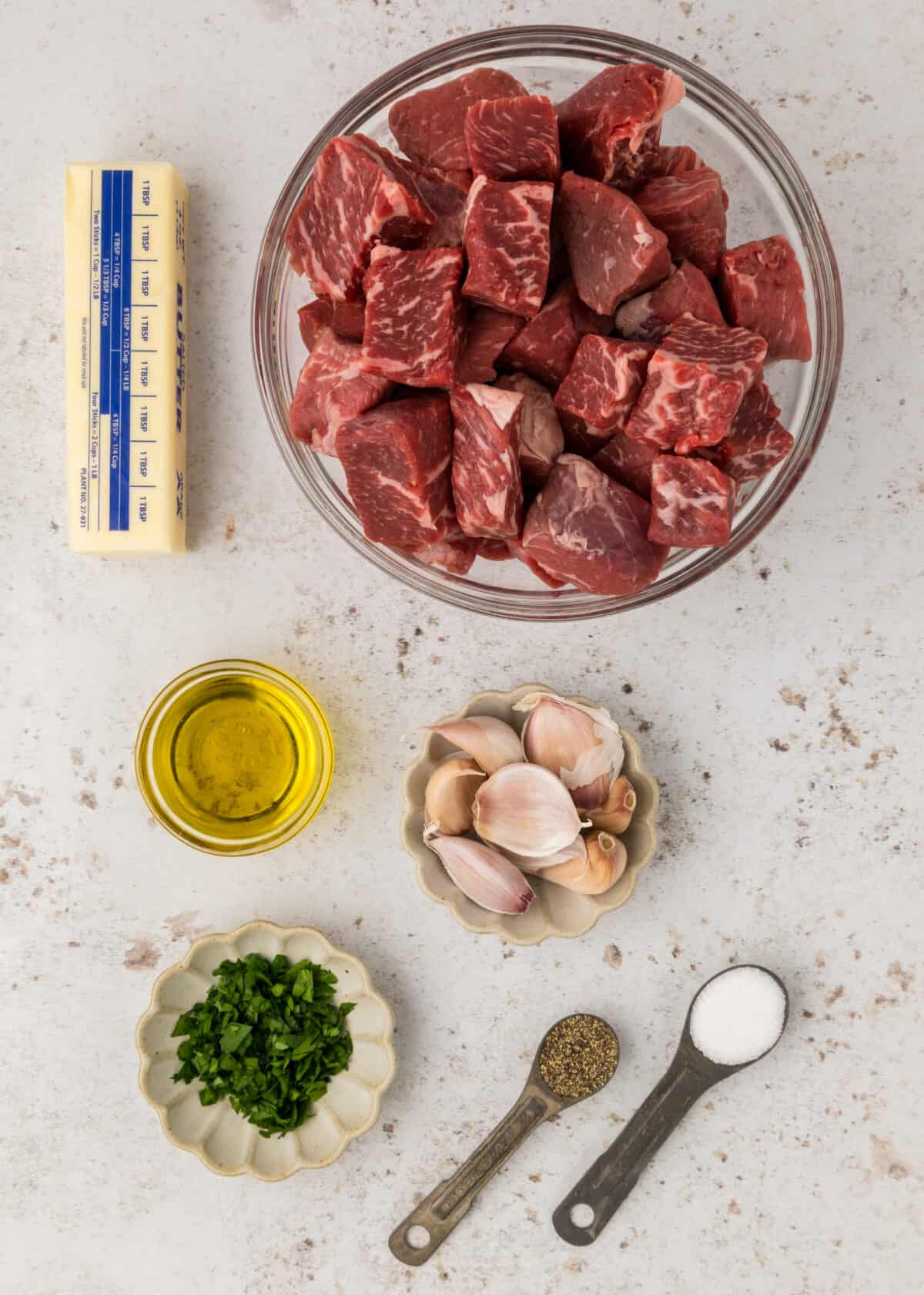 ingredients for the garlic butter steak bites in small bowls on the counter. 