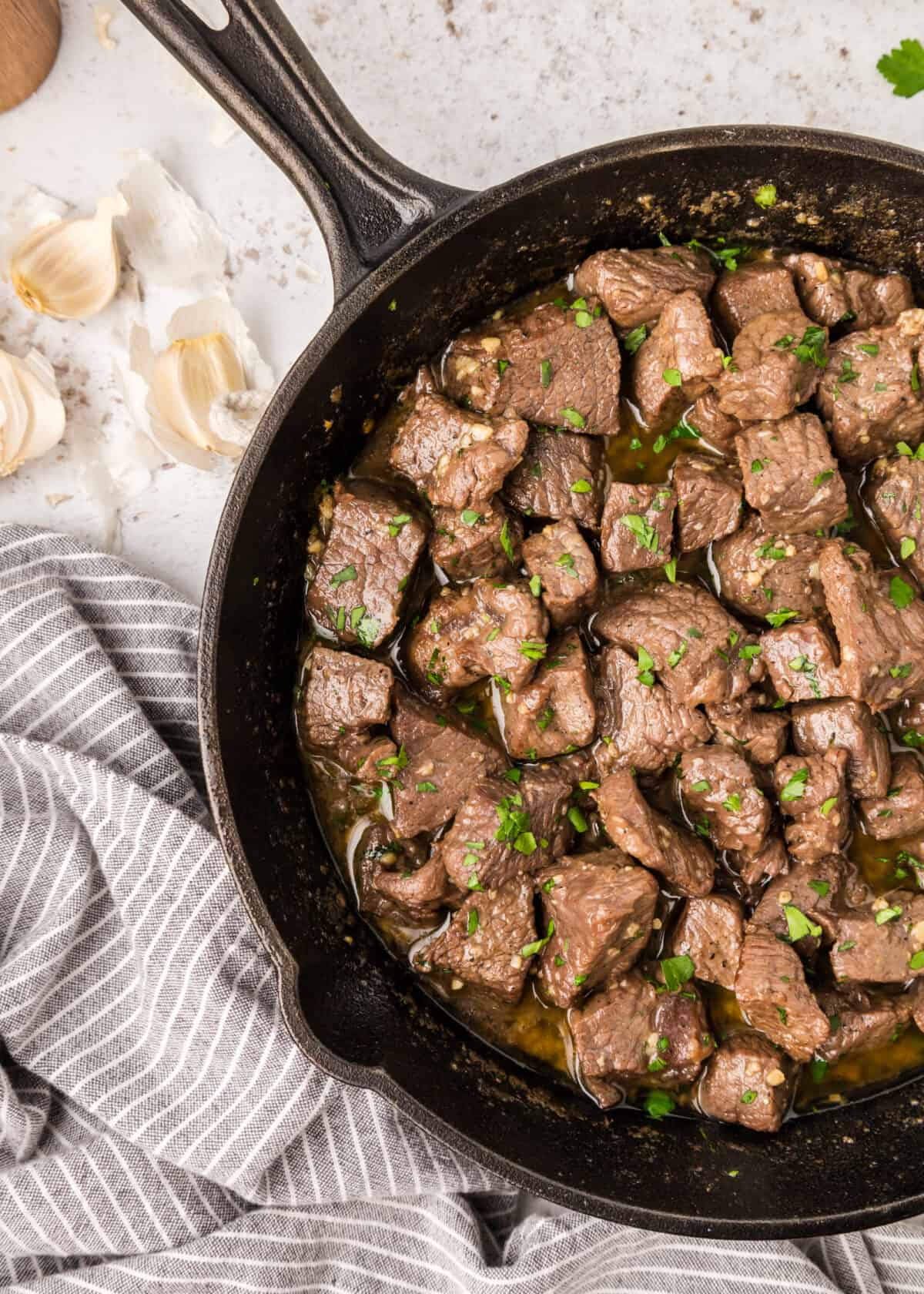 garlic butter steak bites in a large cast iron skillet.