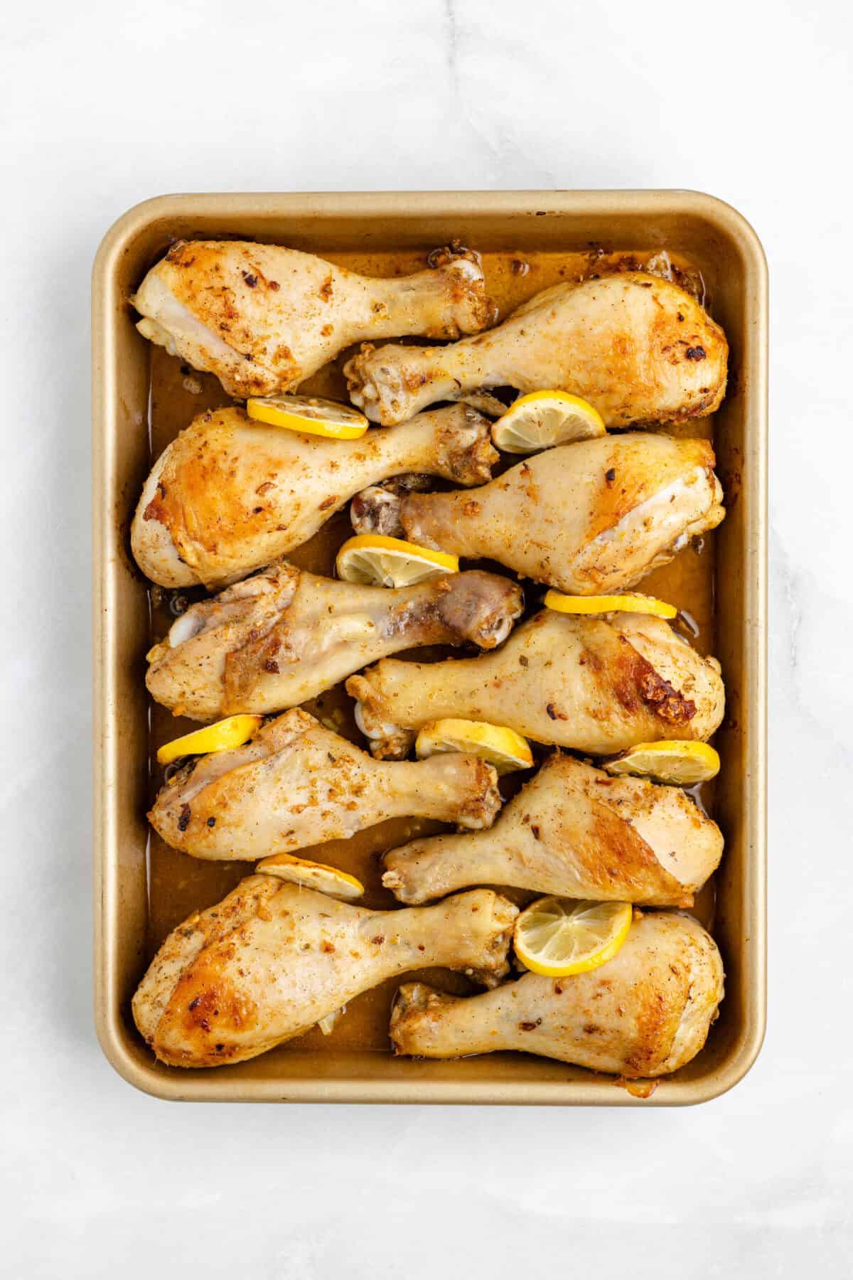 baked lemon chicken drumsticks finished a baking sheet.  