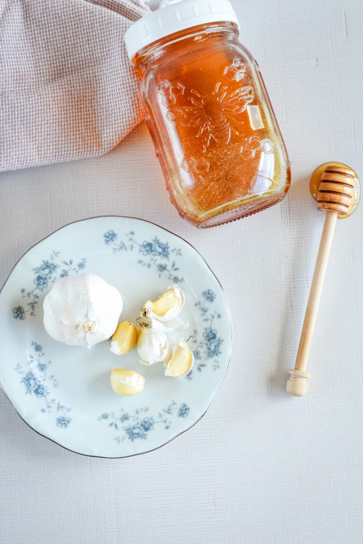 ingredients for the garlic infused honey on a table.