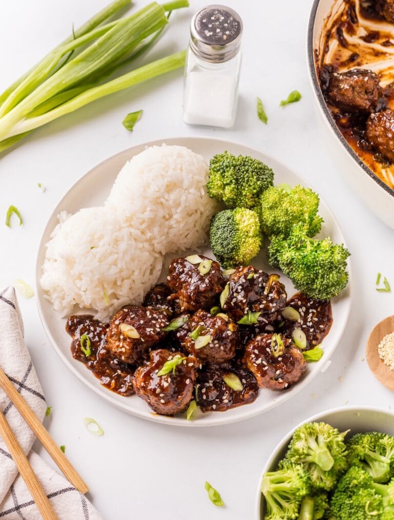 White bowl filled with the finished Mongolian Meatballs, white rice, and steamed broccoli.