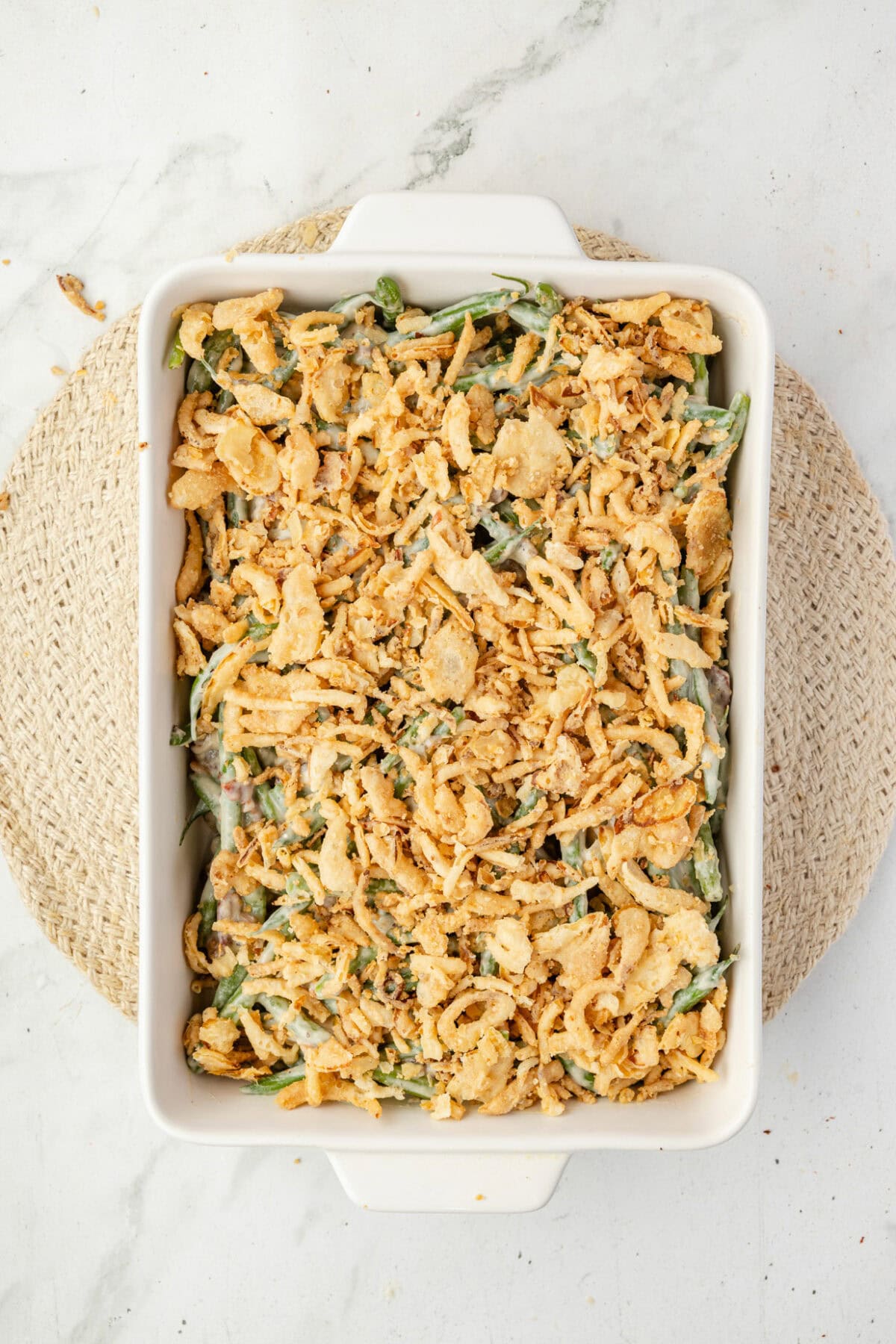 crispy fried onions are added to the top of the green bean casserole mixture. 