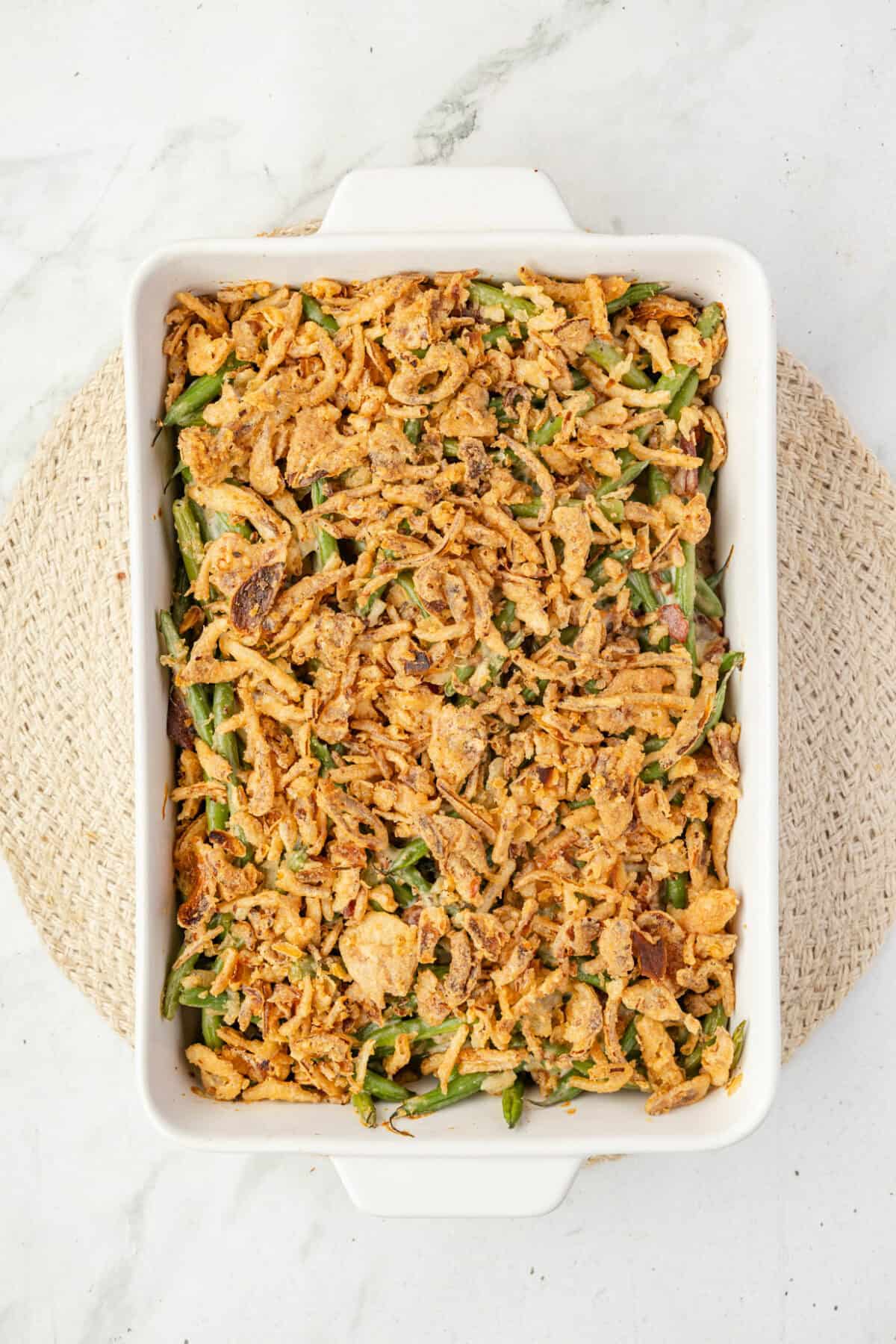 finished fresh green casserole in a white baking dish. 