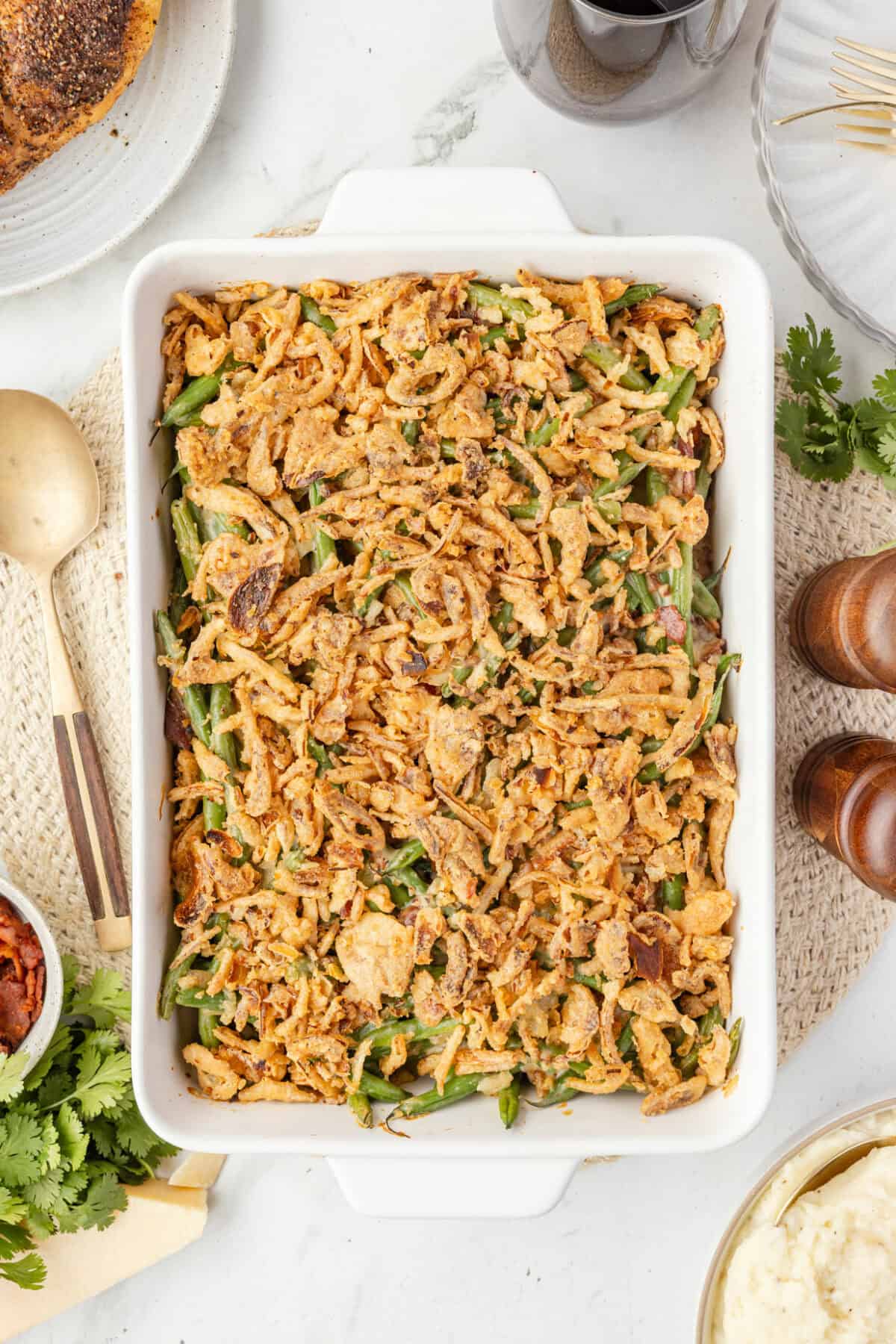 white casserole dish with the Fresh Green Bean Casserole with a Creamy Parmesan Sauce.