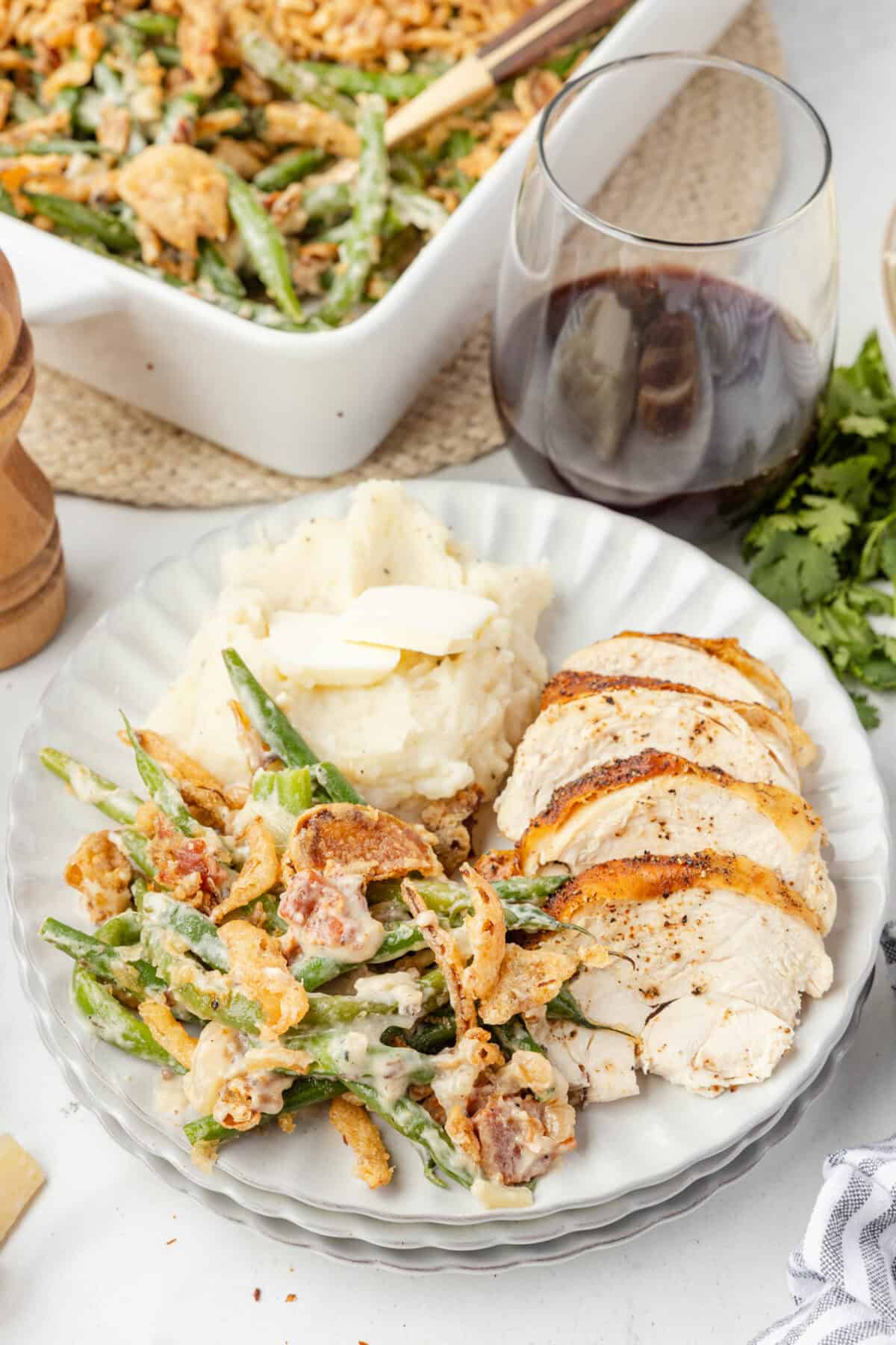 plate of fresh green bean casserole with turkey, and mashed potatoes. 