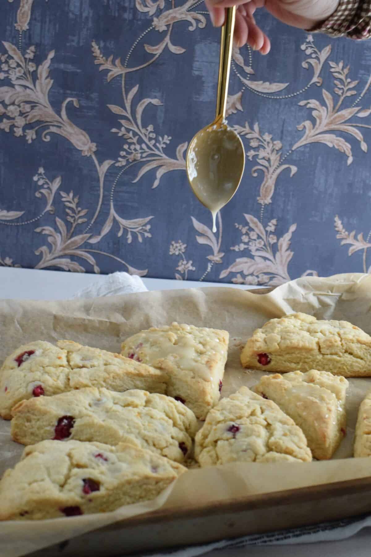 Drizzle of orange glaze over the top of the finished scones.