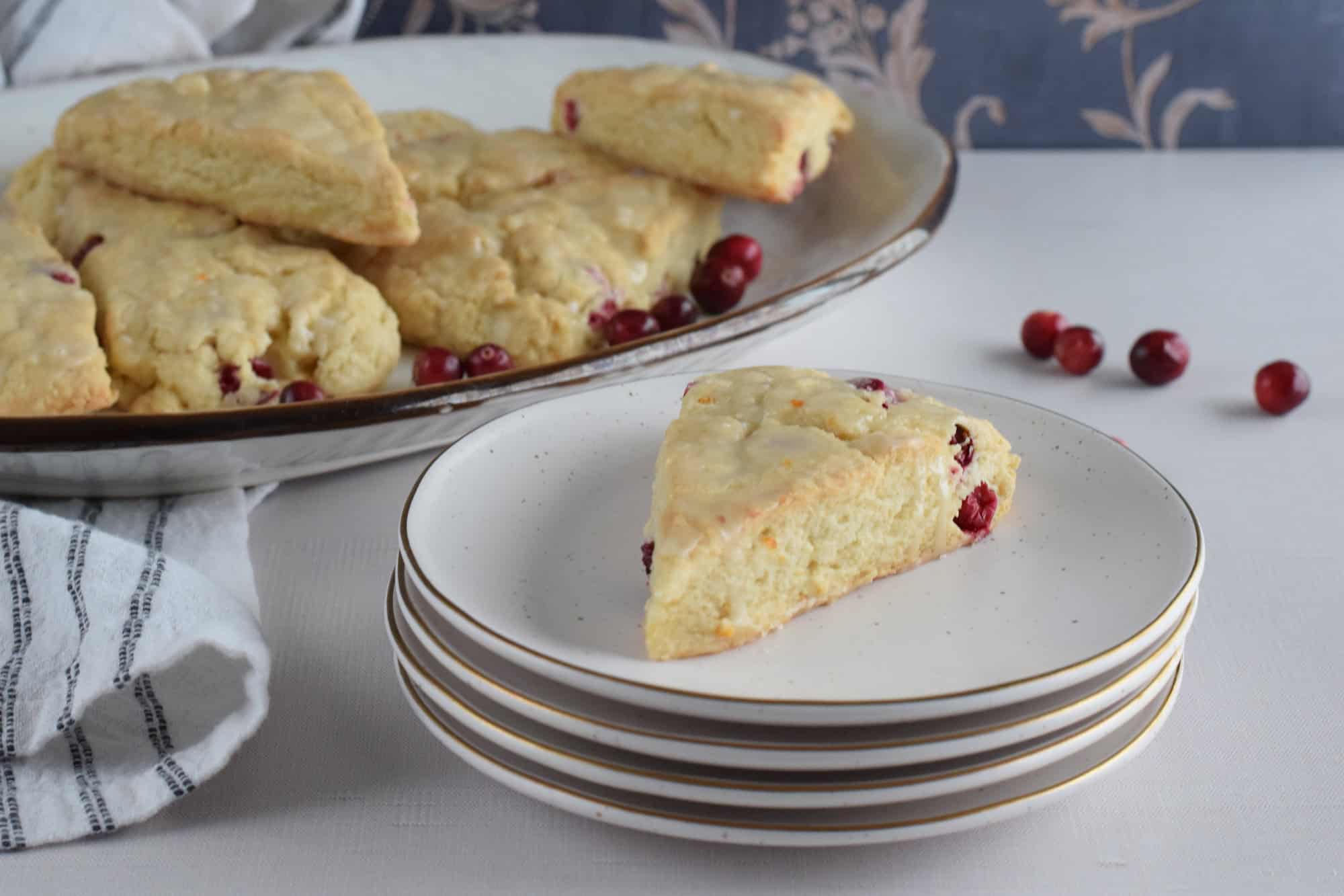 cranberry orange scone on a stack of plates.