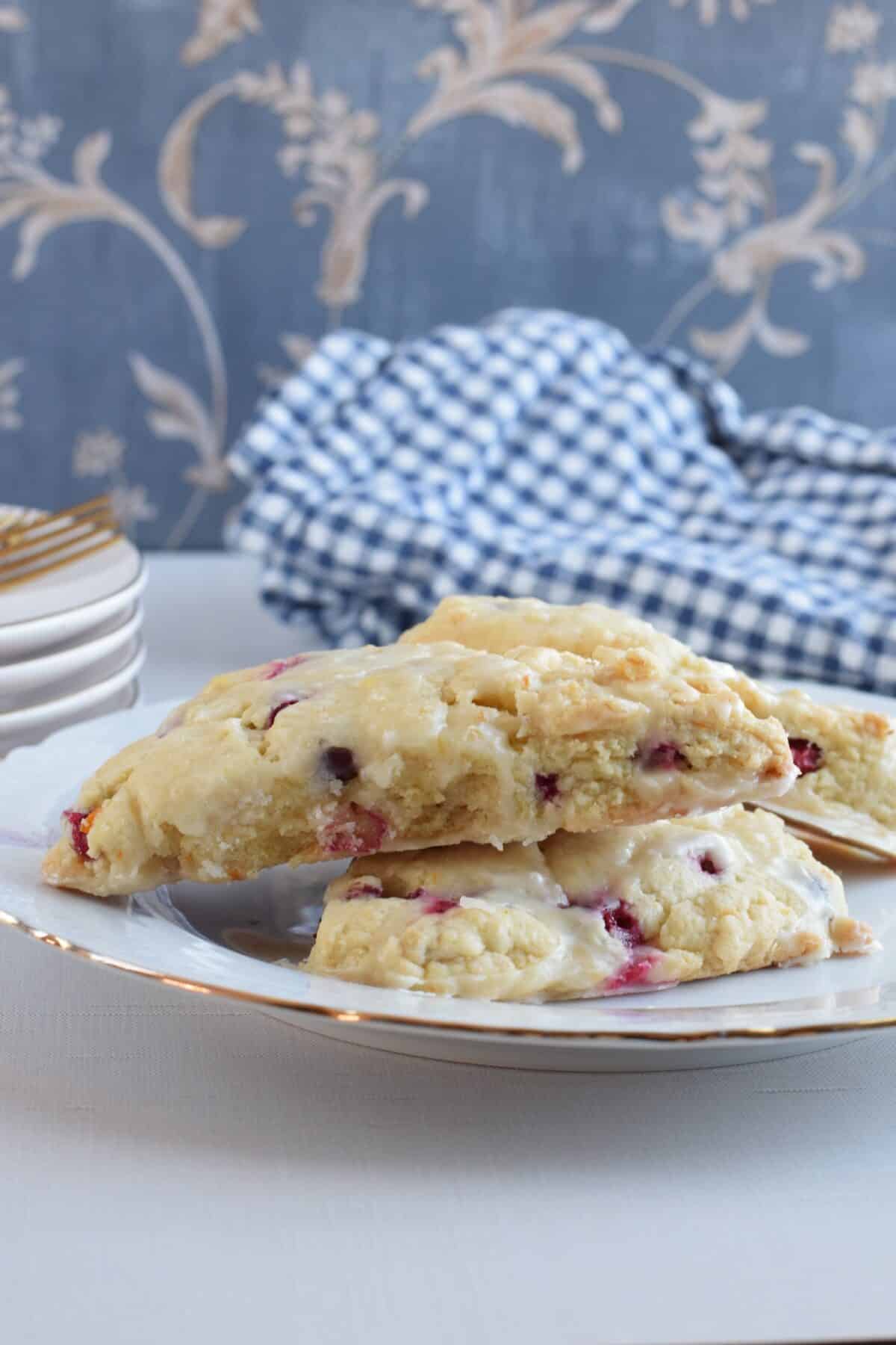 closeup of finished Orange Cranberry Scones stacked on a plate.