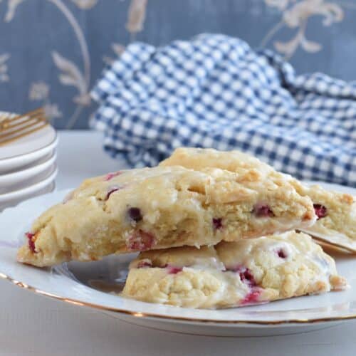 closeup of finished Orange Cranberry Scones stacked on a plate.