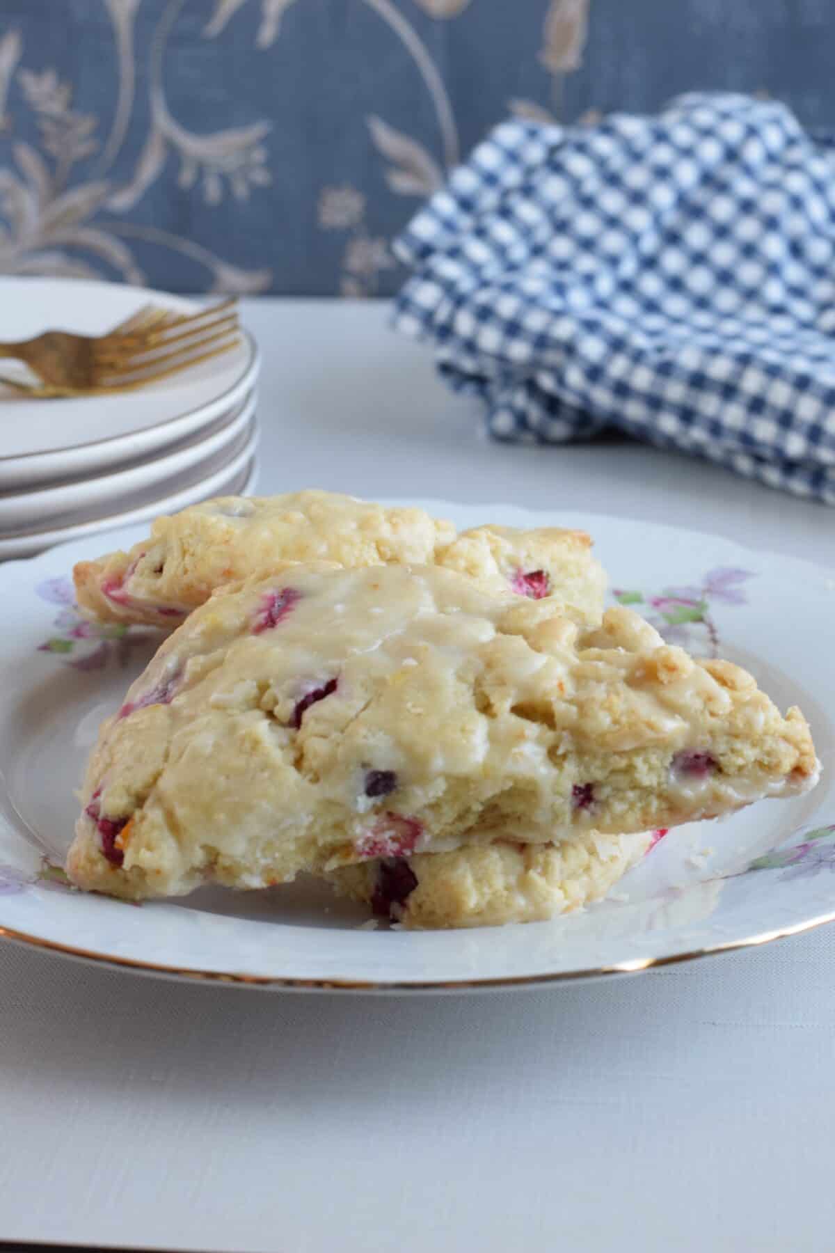 closeup of finished Orange Cranberry Scones stacked on a plate.