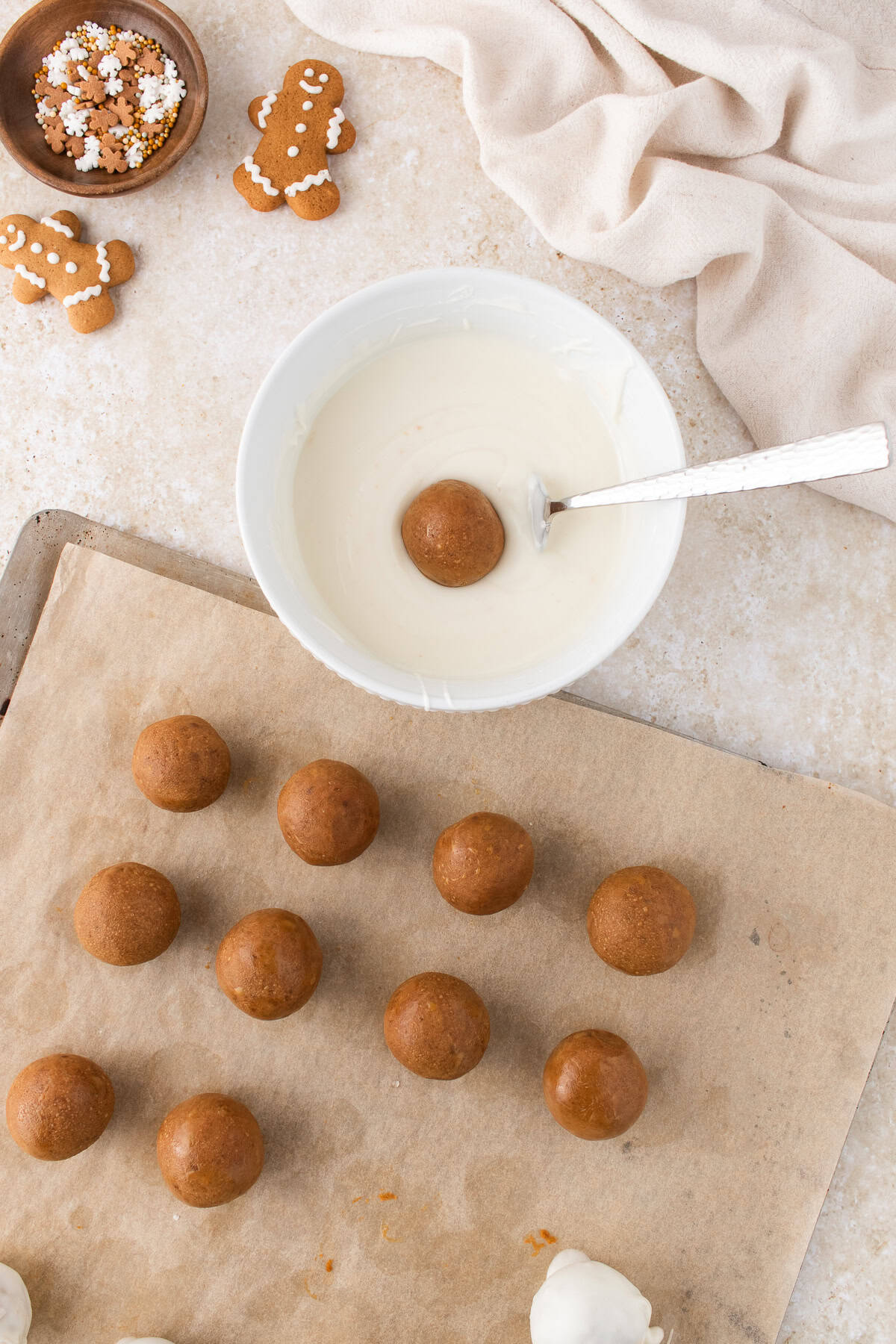 dipping the gingerbread truffles into melted white chocolate. 