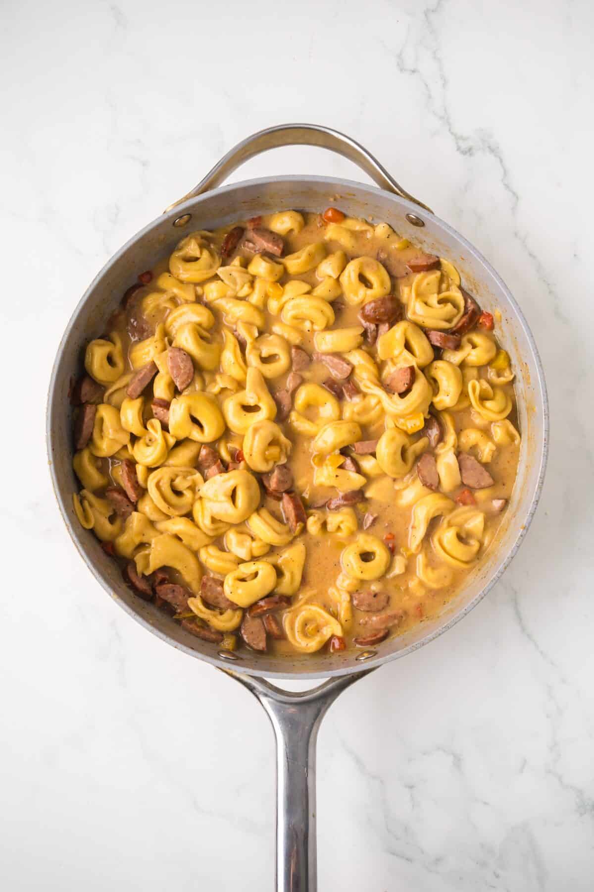 finished creamy cajun tortellini recipe in a large skillet.