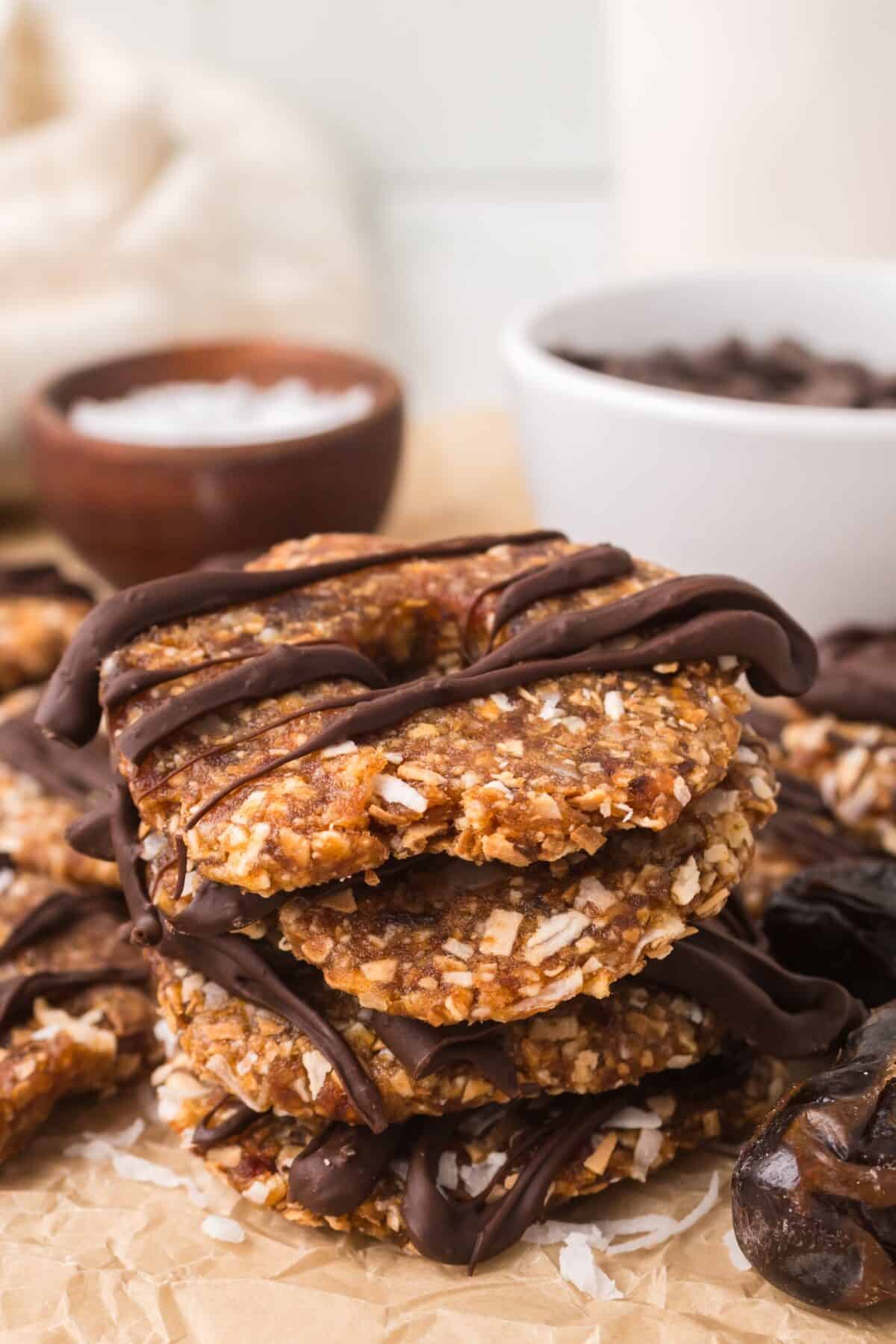 stack of date Samoas on a piece of parchment paper.