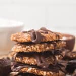 stack of finished date Samoas on parchment paper.