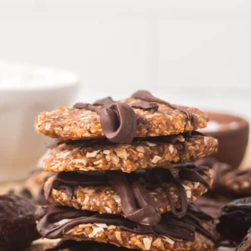 stack of finished date Samoas on parchment paper.