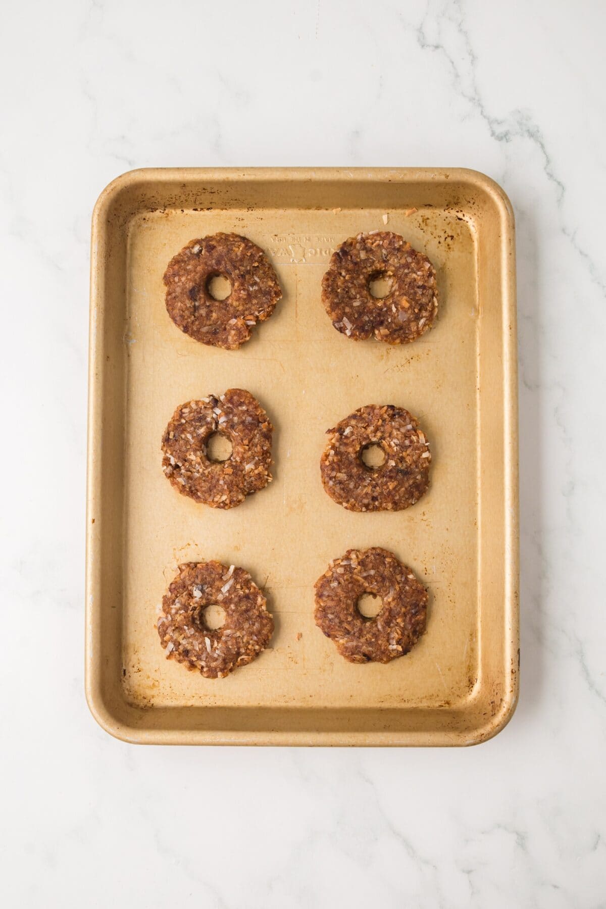 adding the date Samoas to the baking sheet.
