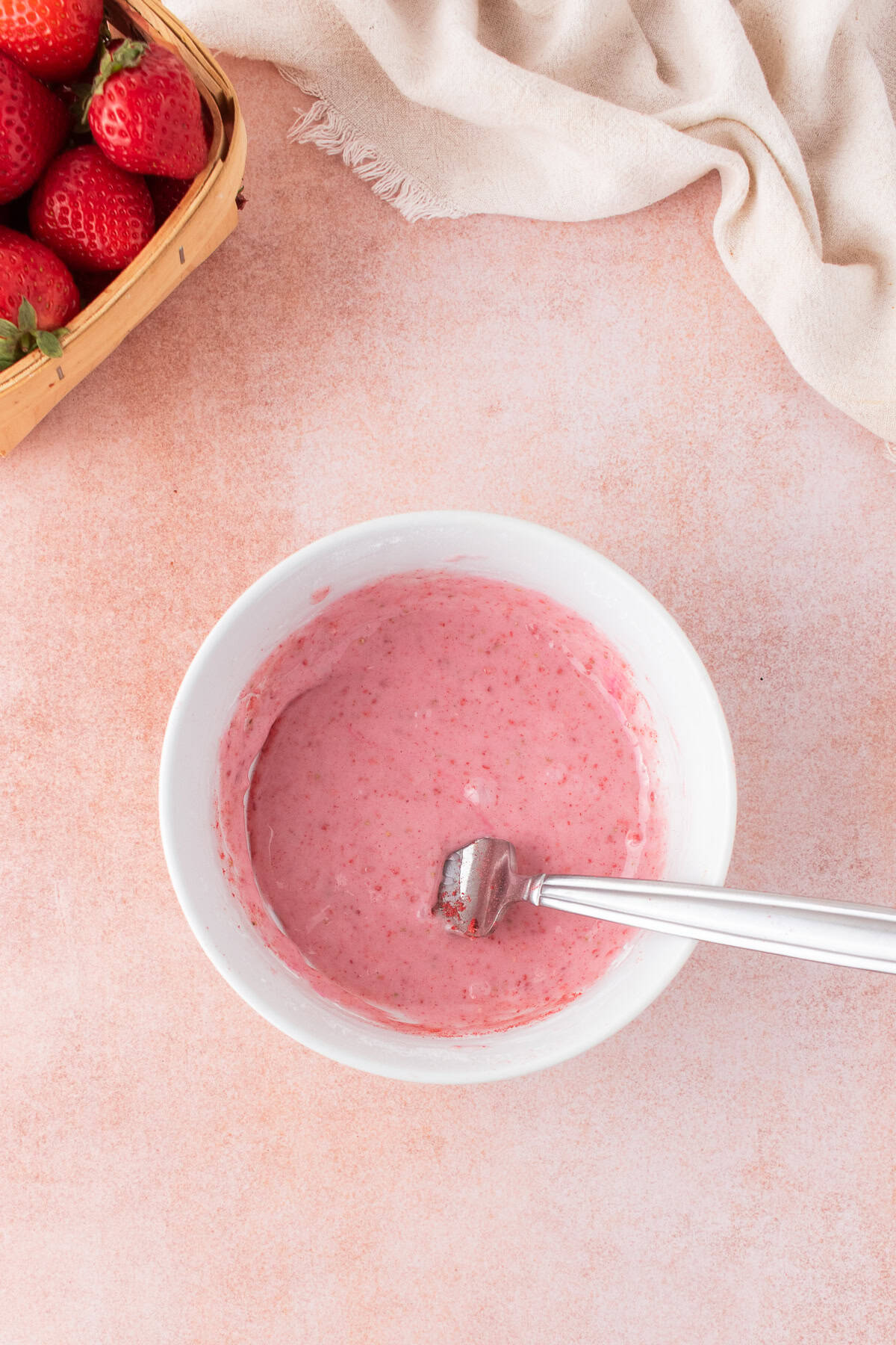 small bowl with finished strawberry glaze for the scones. 