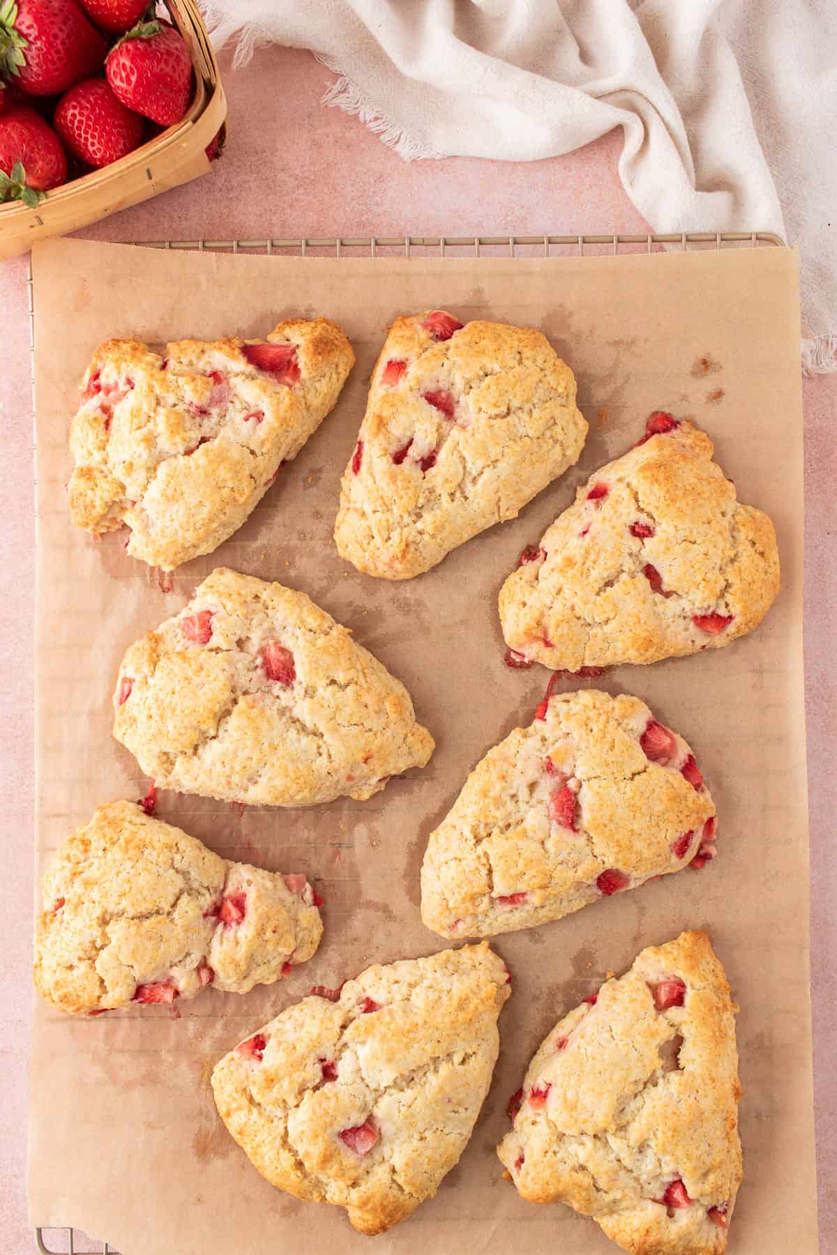 finished scones on a parchment paper lined rack. 