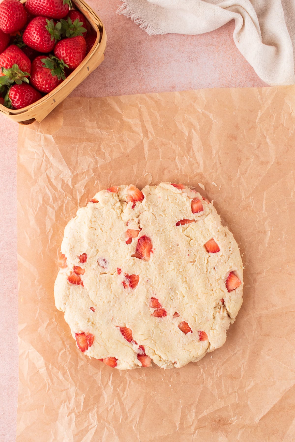 scone dough rolled out on parchment paper. 