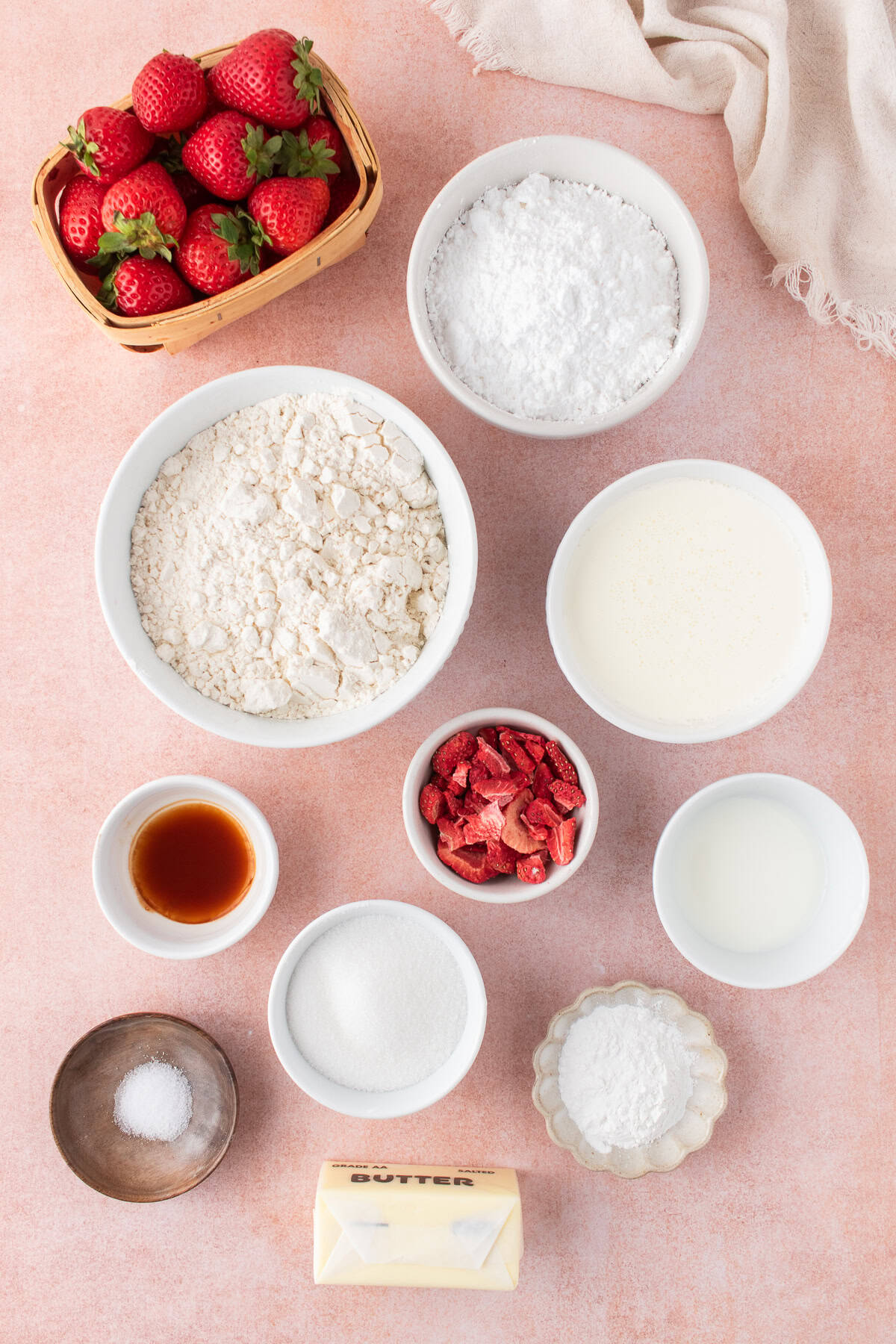ingredients for the strawberry scones in small bowls on countertop. 